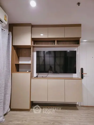 Modern living room with built-in TV cabinet and sleek wooden flooring