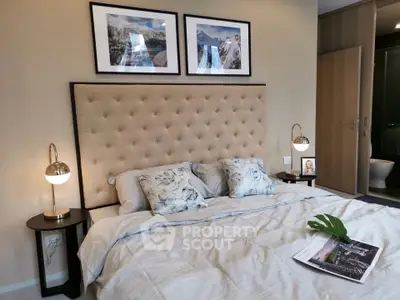 Luxurious bedroom with elegant decor and plush bedding in modern apartment.