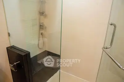 Modern bathroom with glass shower enclosure and sleek fixtures