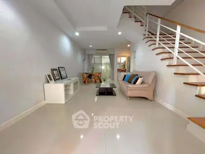 Spacious modern living room with sleek staircase and elegant decor