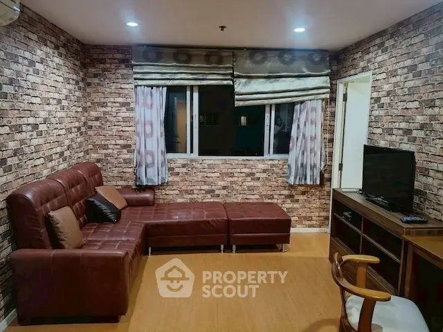 Cozy living room with brick accent wall and leather sectional sofa