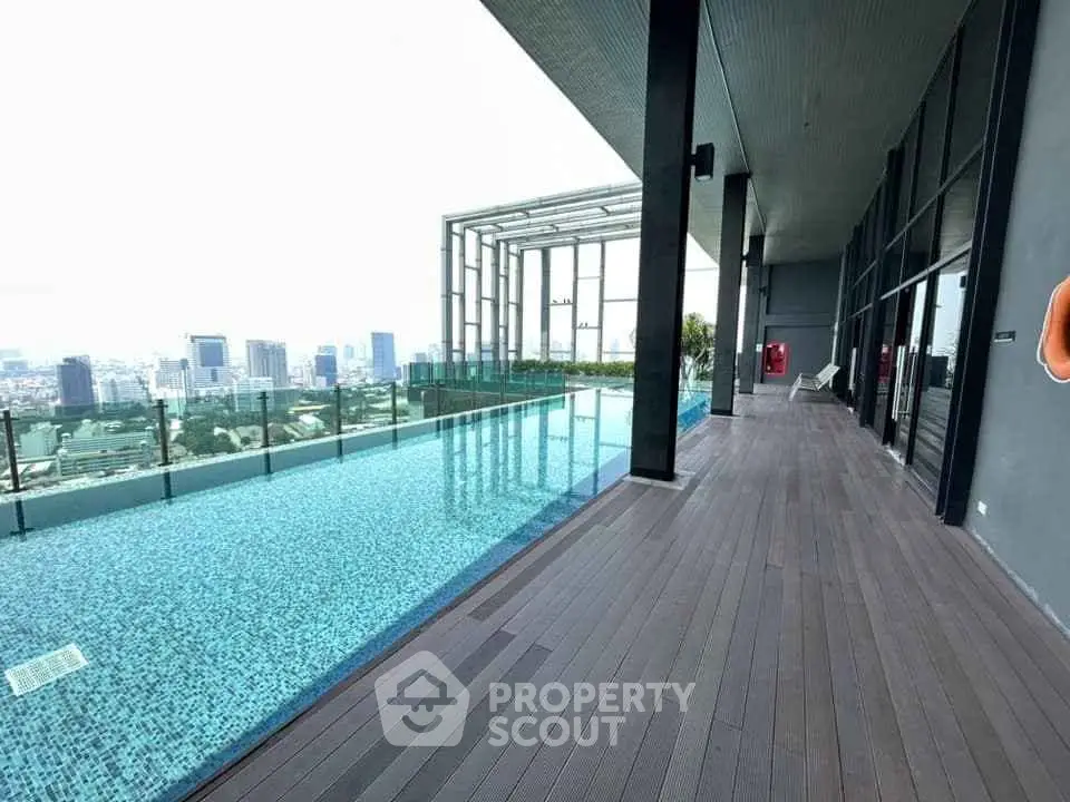 Luxurious rooftop pool with stunning city view and spacious deck area.