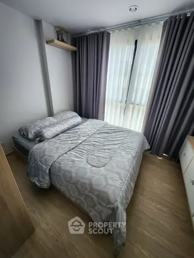 Cozy bedroom with modern decor and large window for natural light