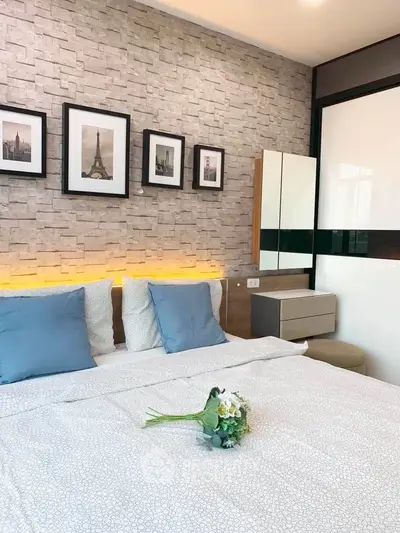 Modern bedroom with stylish decor and cozy ambiance, featuring elegant wall art and soft lighting.
