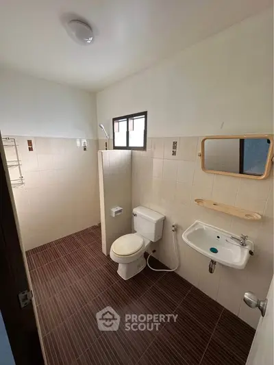 Spacious bathroom with modern fixtures and tiled flooring
