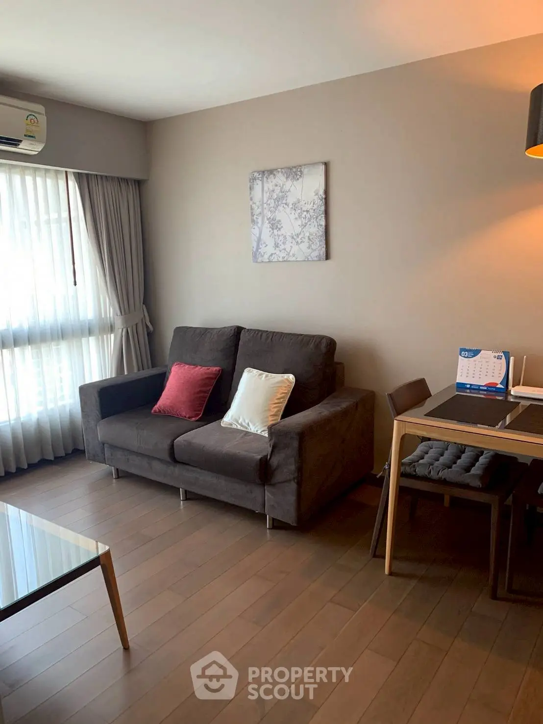 Cozy living room with modern sofa and dining area, perfect for urban living.