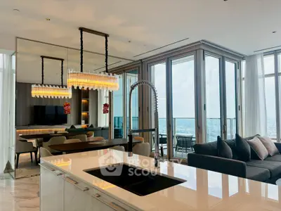 Luxurious modern living room with open kitchen and stunning city view from high-rise apartment.