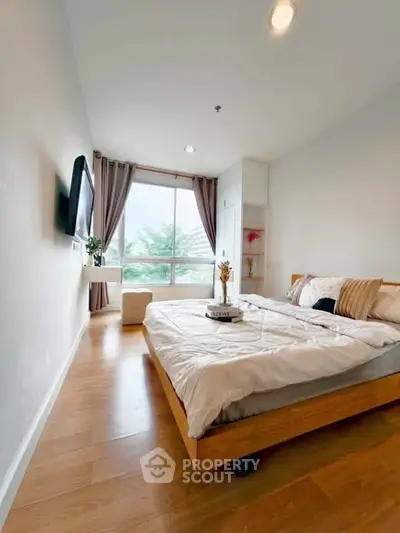 Modern bedroom with large window and stylish decor