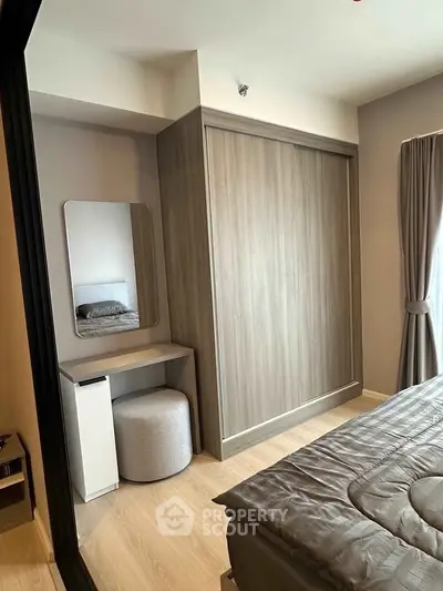 Modern bedroom with sleek wardrobe and cozy decor in a stylish apartment.