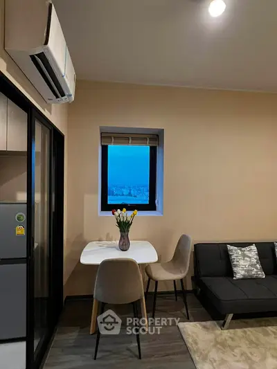 Cozy modern living room with dining area and city view