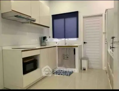 Modern kitchen with sleek cabinetry and built-in appliances in a bright, minimalist design.