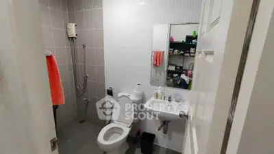 Modern bathroom with sleek fixtures and ample storage space.