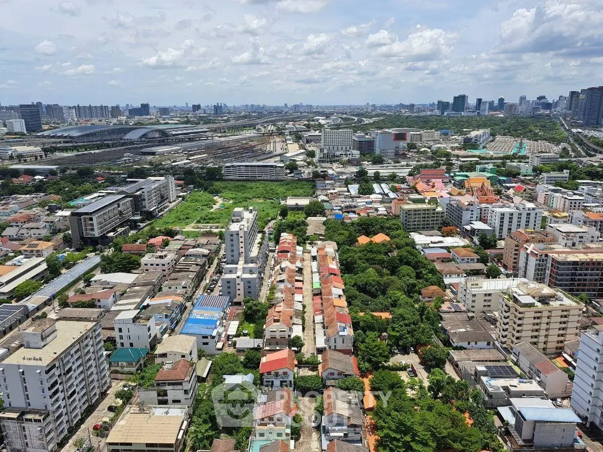 Stunning aerial view of urban landscape with diverse architecture and lush greenery, showcasing city living.