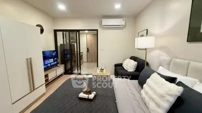 Modern bedroom with stylish decor and cozy seating area in a contemporary apartment.
