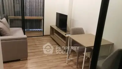 Modern living room with sleek furniture and wooden flooring in a cozy apartment.