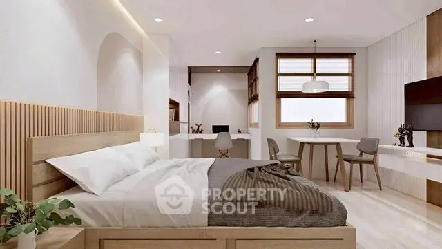 Modern bedroom with stylish decor and cozy workspace in a bright, open layout.