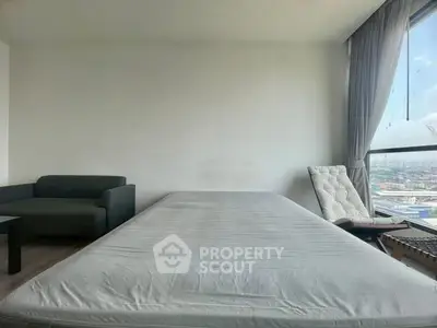 Spacious bedroom with panoramic city view and modern furnishings