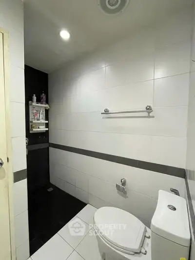 Modern bathroom with sleek white tiles and a walk-in shower