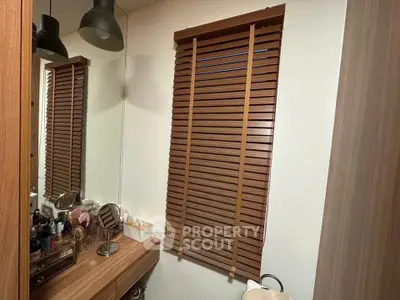 Cozy bathroom with wooden blinds and vanity mirror
