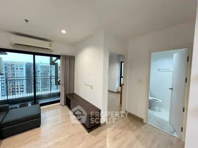 Modern apartment interior with balcony view, featuring sleek flooring and contemporary design.