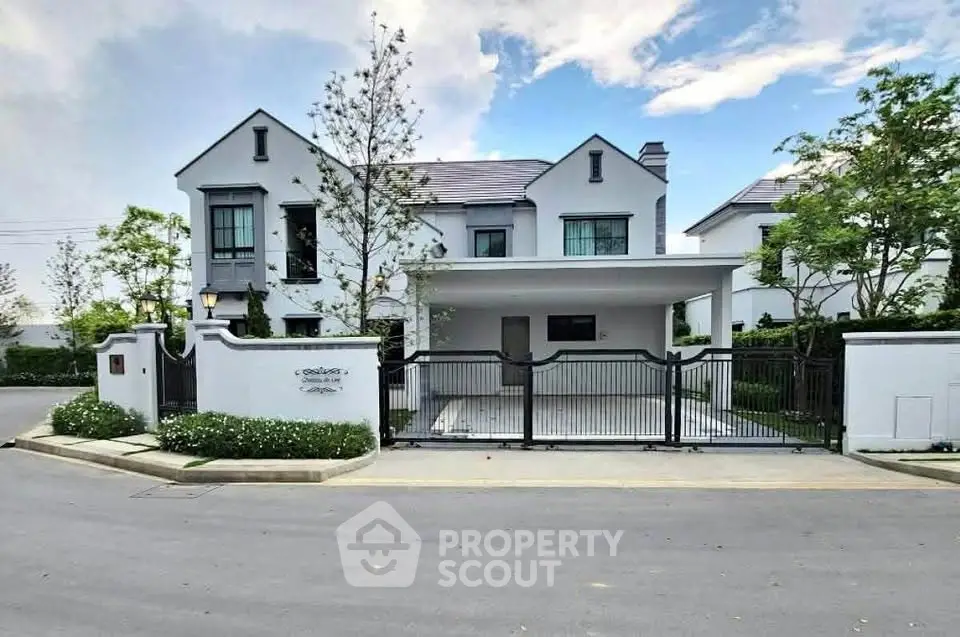 Elegant modern house with spacious driveway and lush greenery in a serene neighborhood.