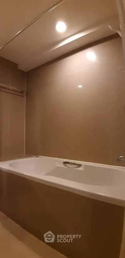 Modern bathroom with sleek bathtub and elegant tile design