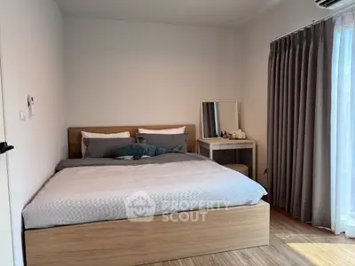 Cozy bedroom with modern decor and natural light, featuring a comfortable bed and stylish curtains.