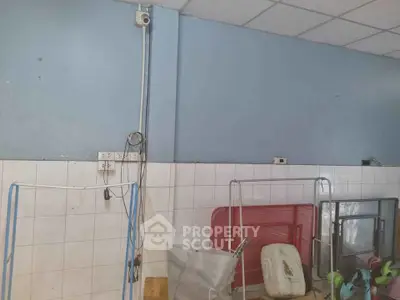 Utility room with tiled walls and various storage items
