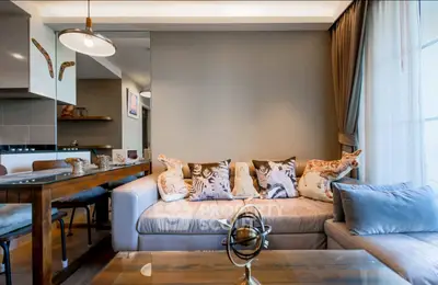 Stylish living room with modern decor and cozy seating area, perfect for relaxation and entertaining.