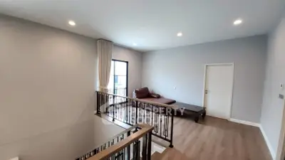 Spacious modern living area with natural light and stylish railing