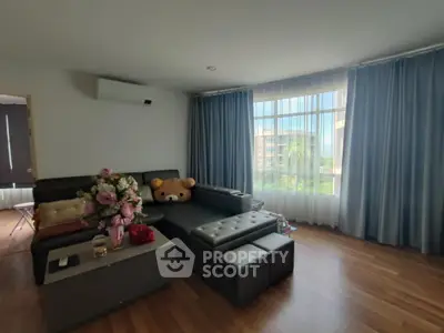 Spacious living room with large windows and modern decor