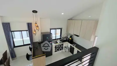 Modern kitchen with sleek design, featuring open layout and stylish lighting in a contemporary home.