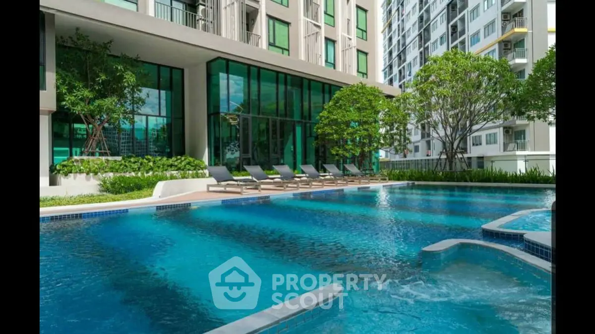 Luxurious condominium with a stunning outdoor pool and lush greenery.