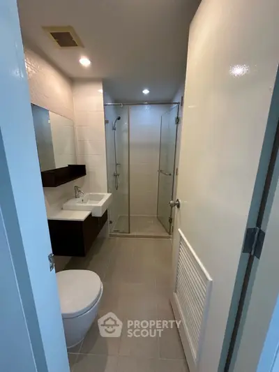 Modern bathroom with glass shower and sleek fixtures