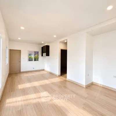 Spacious and bright living room with wooden flooring and recessed lighting