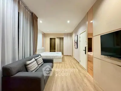 Modern studio apartment with cozy living area and stylish decor