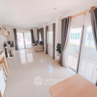 Spacious living room with modern decor and large windows for natural light