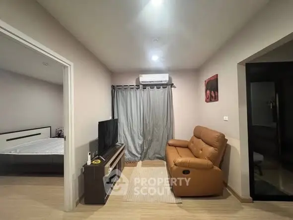 Cozy living room with modern decor and adjacent bedroom view