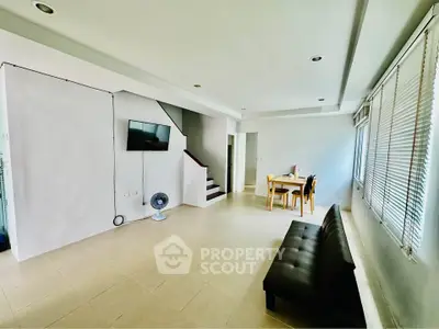 Spacious living room with modern decor and natural light