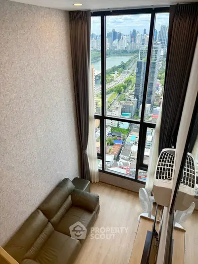 Stunning high-rise apartment with panoramic city view and cozy living area.