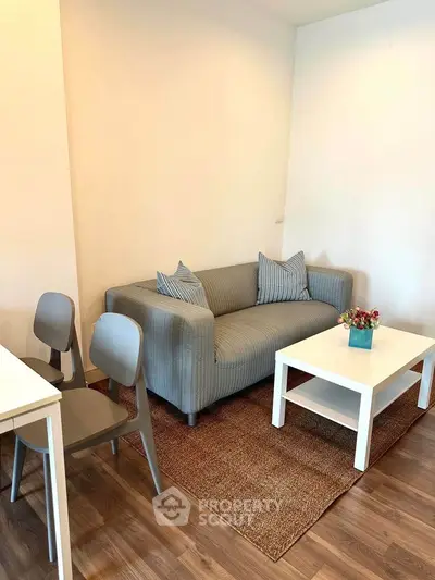 Cozy living room with modern sofa and stylish decor, perfect for relaxation.