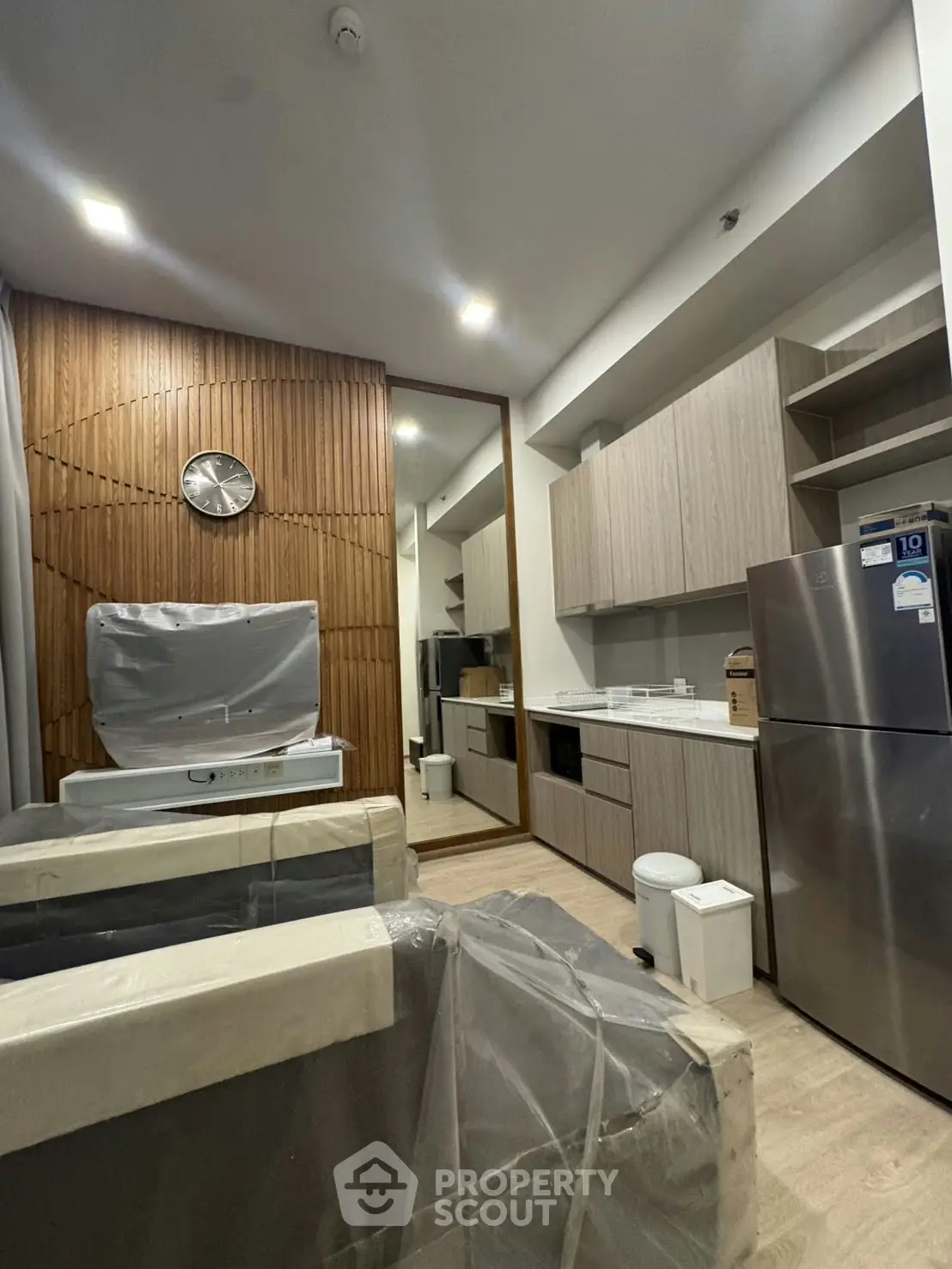 Modern kitchen with sleek cabinetry and stainless steel appliances in a stylish apartment.