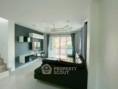 Modern living room with sleek black sofa and stylish entertainment center