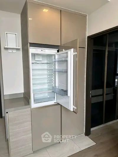 Modern kitchen with built-in fridge and sleek cabinetry