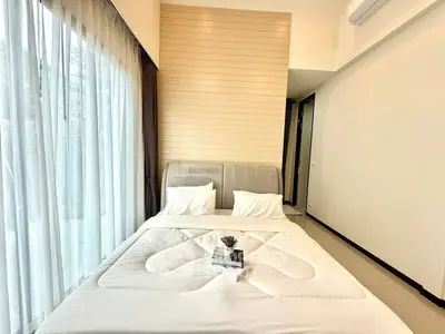 Modern bedroom with large window and stylish decor