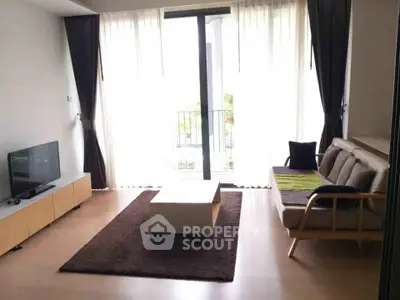 Modern living room with natural light and stylish furniture in a cozy apartment.