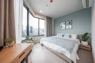 Spacious modern bedroom with large windows and city view, featuring stylish decor and natural light.