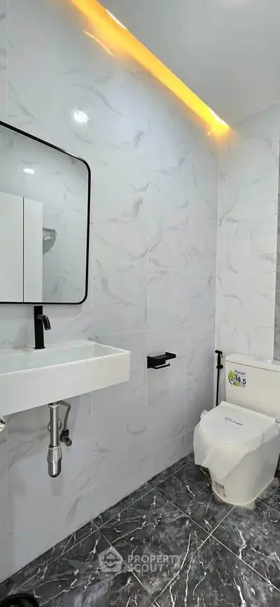Modern bathroom with sleek fixtures and elegant marble tiles