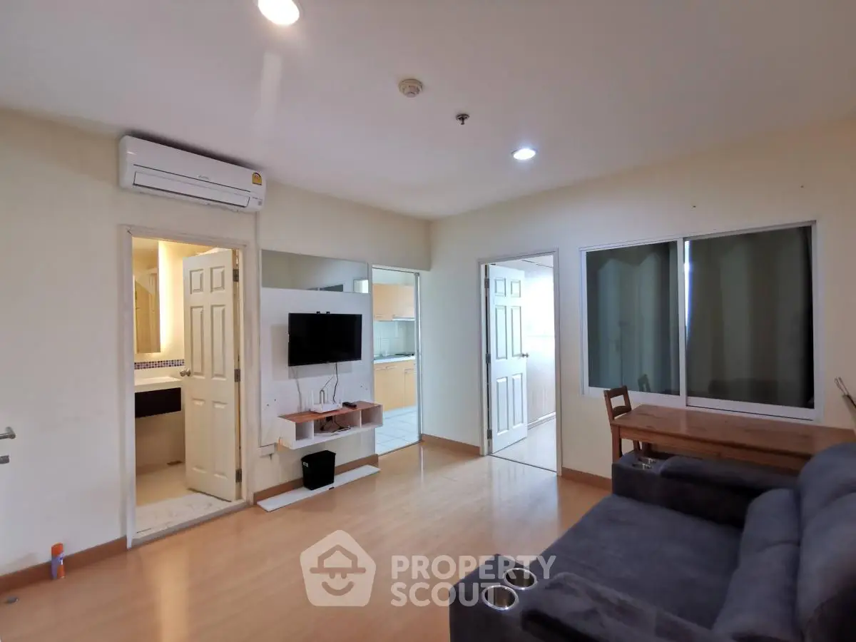 Spacious living room with modern amenities and open kitchen layout