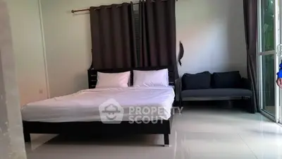 Spacious bedroom with modern decor and natural light